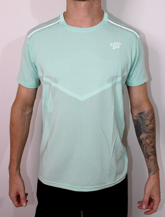 Person wearing a light green athletic shirt with a logo on a white background